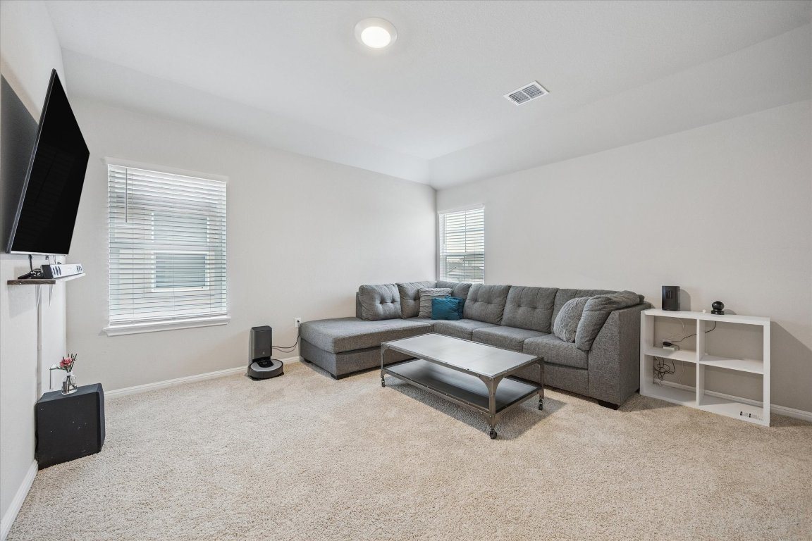 724 Aster Place Bastrop, TX 78602 - Photo 10 of 16 a living room with furniture and a flat screen tv