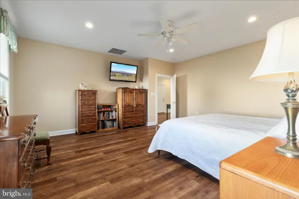 a view of a big house with a big yard and large trees