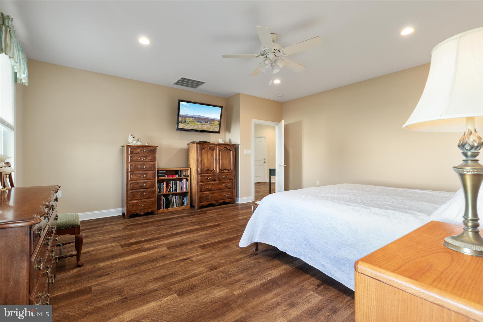 199 Laurel Grove Road Winchester, VA 22602 - Photo 26 of 97 a spacious bedroom with a bed and a chandelier