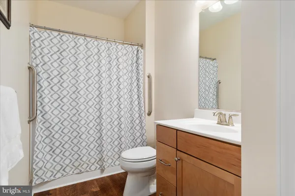 a front view of a house with a big yard and large tree