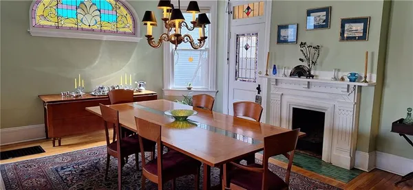 a view of a dining room with furniture and a fireplace