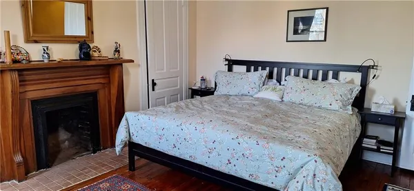 a bedroom with a bed and a fireplace