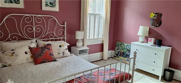 a bedroom with a bed and with furniture