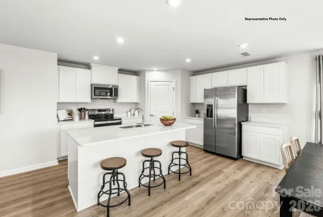 a kitchen with wooden cabinets a refrigerator stove a sink and dishwasher