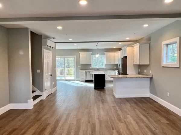 a large kitchen with kitchen island a sink stainless steel appliances and cabinets