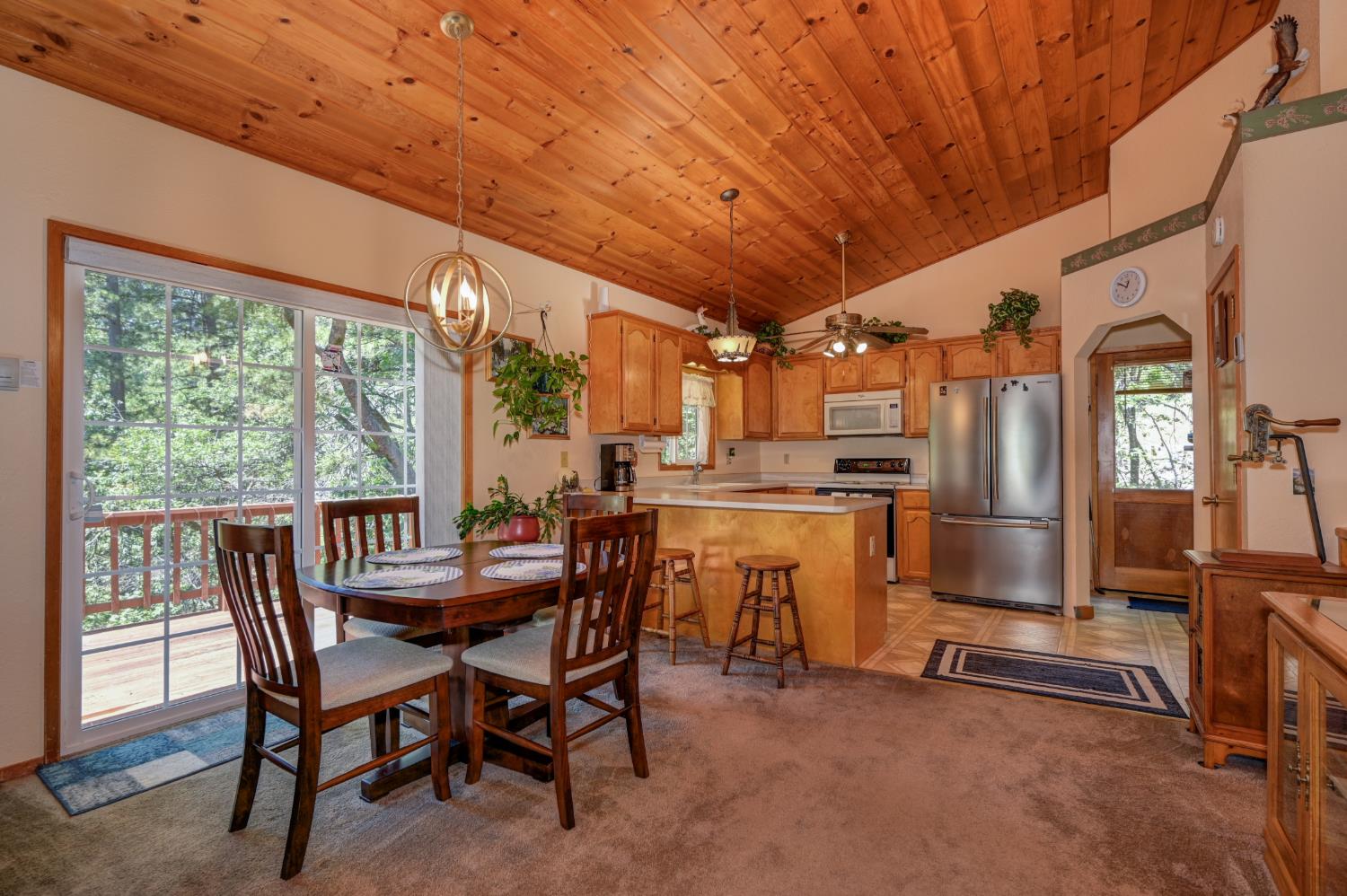 23998 Stable Road Sonora, CA 95370 - Photo 10 of 41 a dining room with furniture and a kitchen view