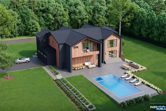 an aerial view of a house with swimming pool garden and patio