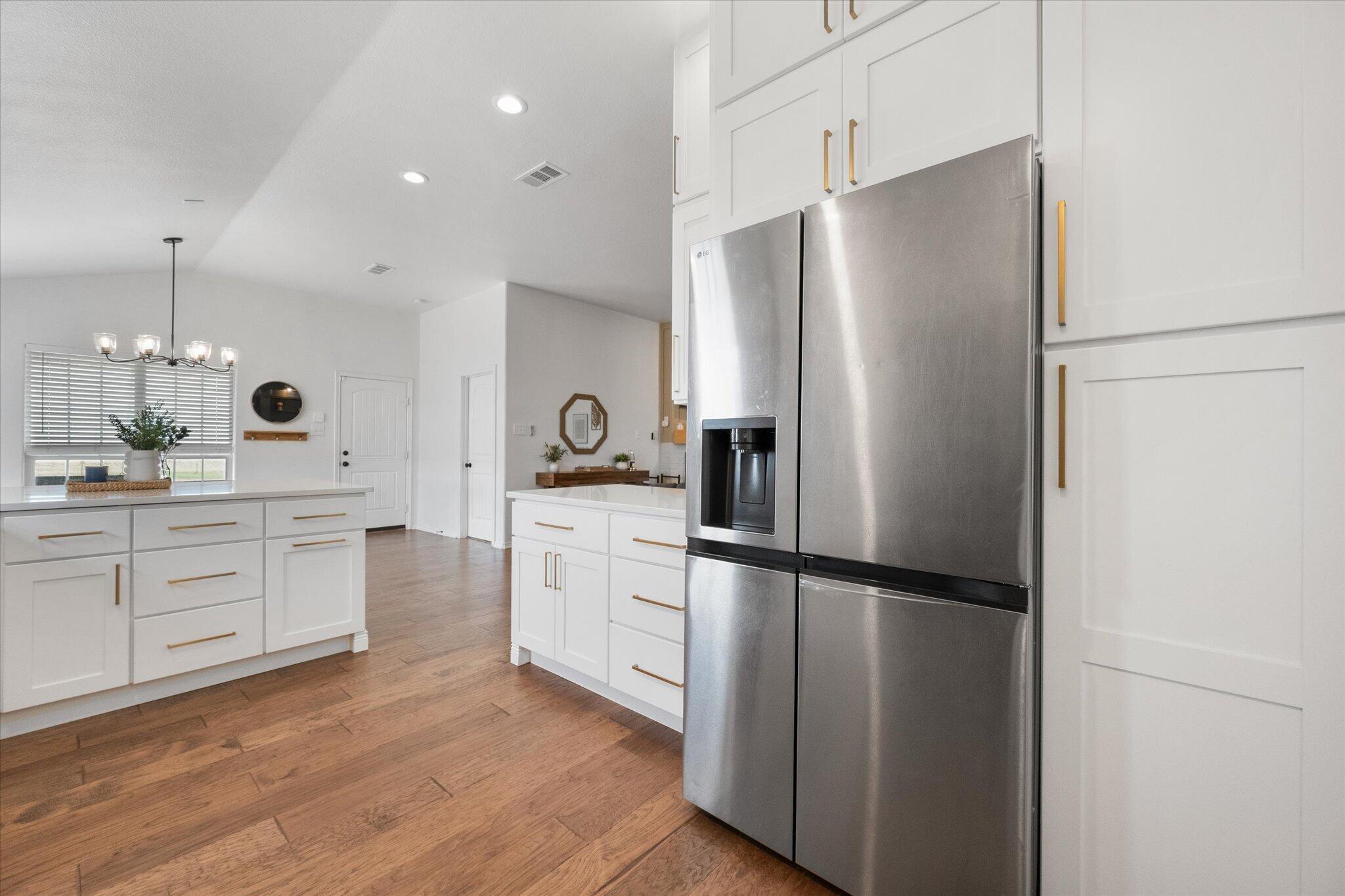 1429 Fm 211 Wilson, TX 79381 - Photo 16 of 43 a kitchen with white cabinets and stainless steel appliances