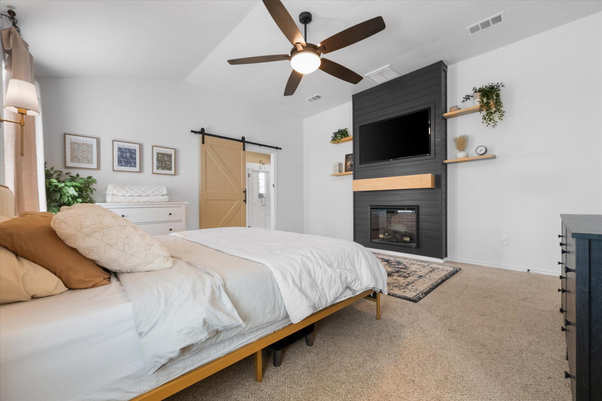 1429 Fm 211 Wilson, TX 79381 - Photo 26 of 43 a spacious bedroom with a bed and a flat screen tv