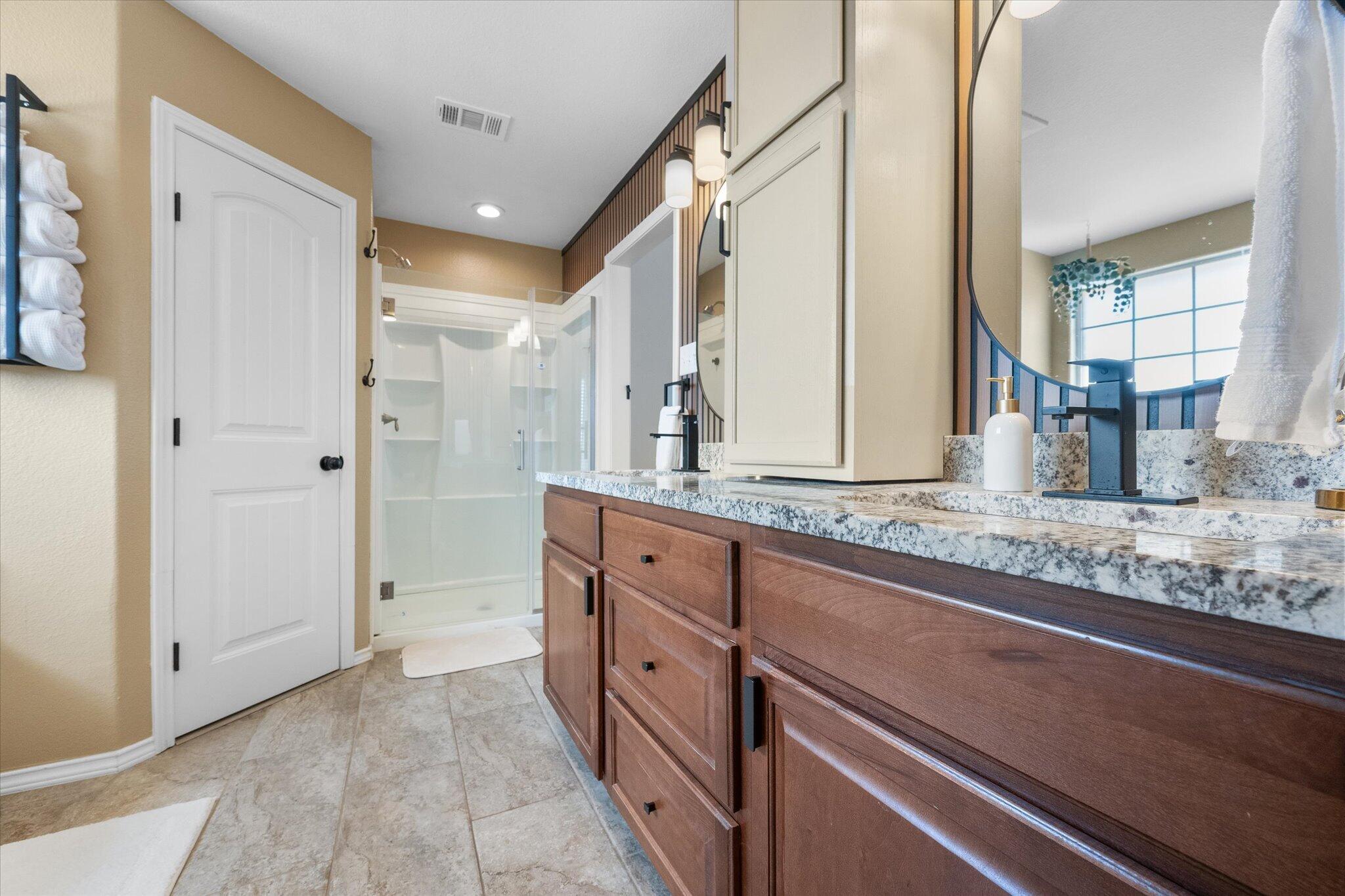 1429 Fm 211 Wilson, TX 79381 - Photo 29 of 43 a bathroom with granite countertop double vanity and a mirror