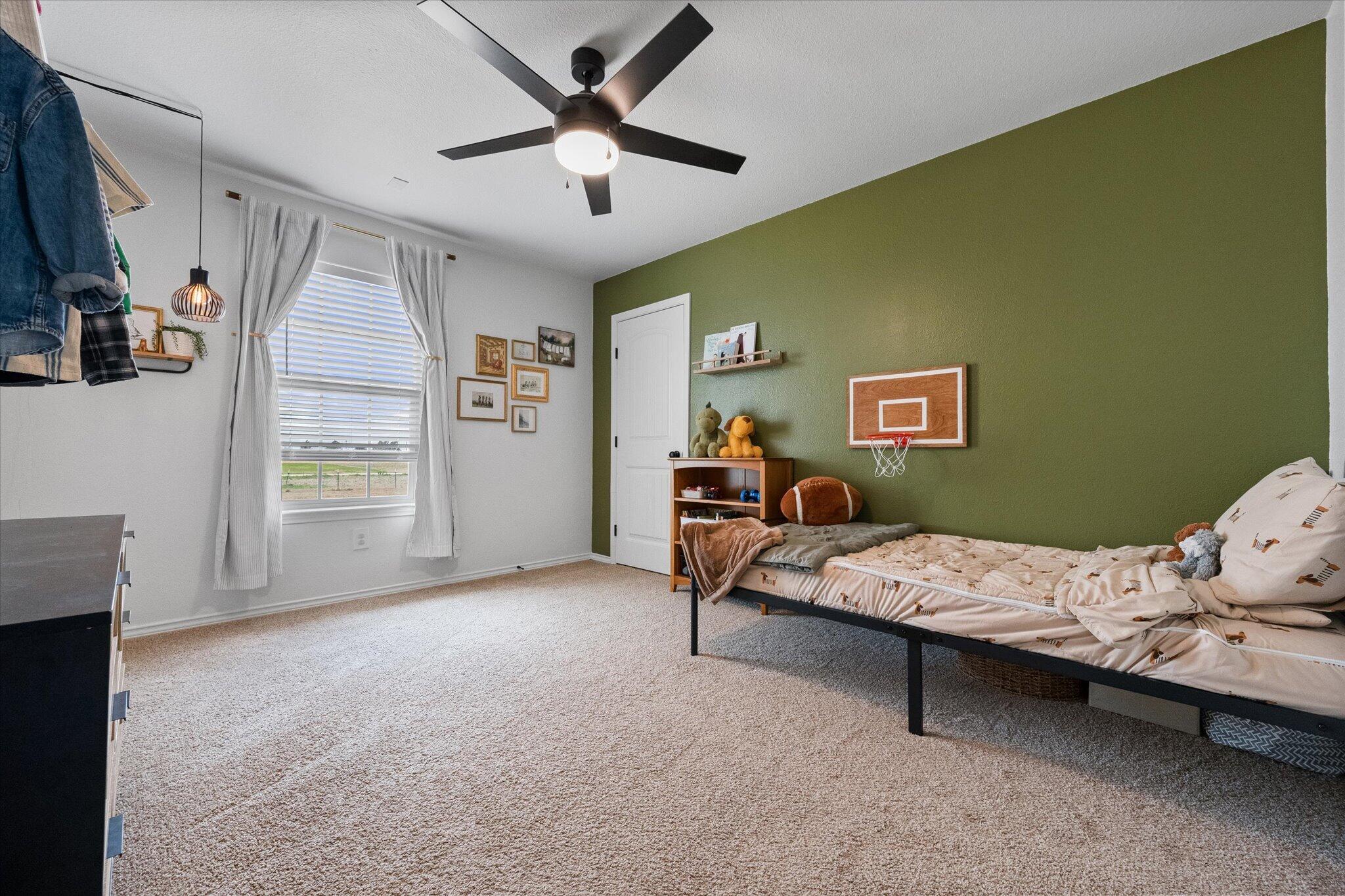 1429 Fm 211 Wilson, TX 79381 - Photo 34 of 43 a bedroom with a bed and a ceiling fan