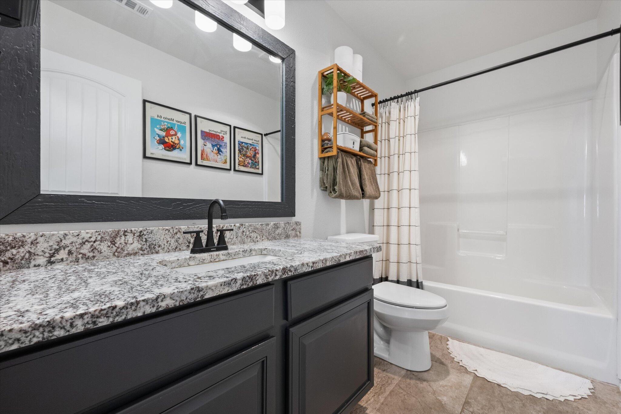 1429 Fm 211 Wilson, TX 79381 - Photo 35 of 43 a bathroom with a granite countertop sink a toilet and shower