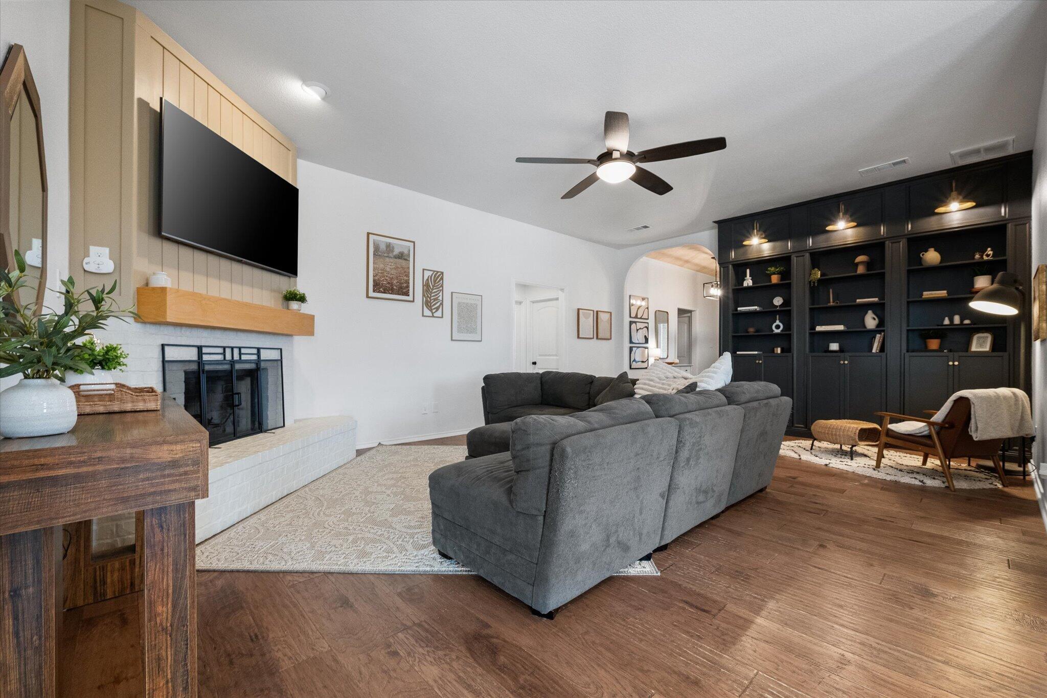 1429 Fm 211 Wilson, TX 79381 - Photo 8 of 43 a living room with fireplace furniture and a flat screen tv