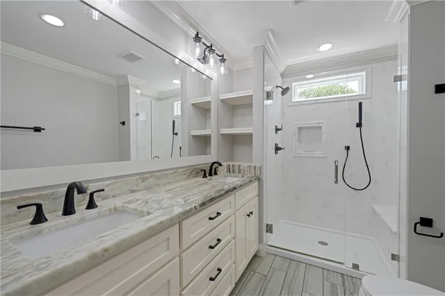 a bathroom with a granite countertop sink mirror and a shower