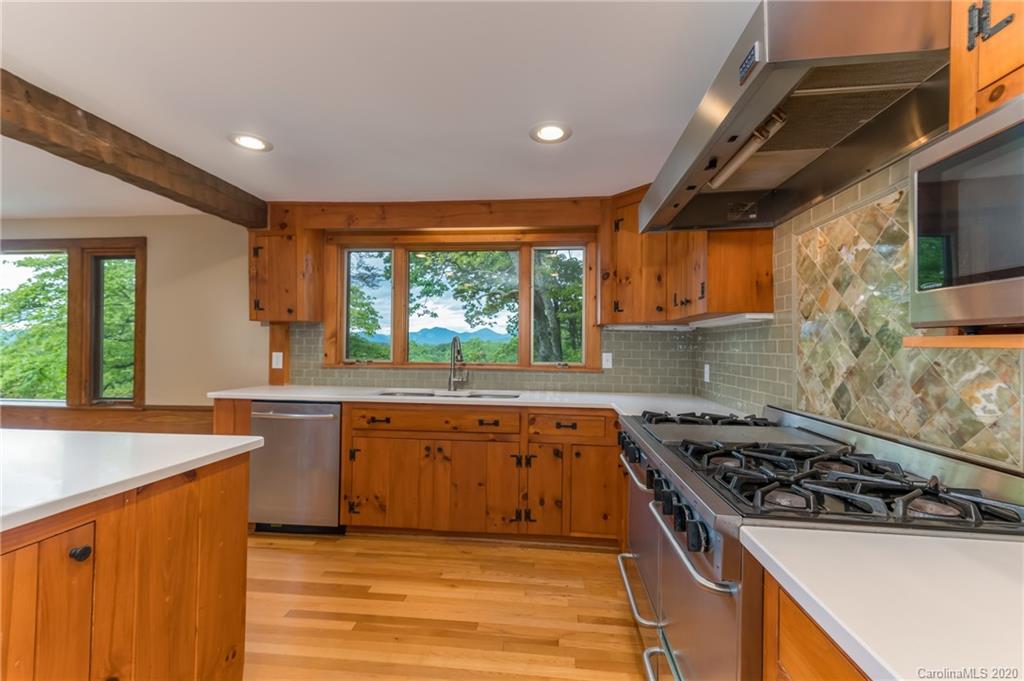 2468 Peniel Road Columbus, NC 28722 - Photo 11 of 47 a kitchen with stainless steel appliances a sink stove and cabinets