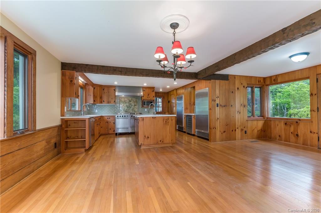 2468 Peniel Road Columbus, NC 28722 - Photo 15 of 47 a view of a dining room with furniture a chandelier and wooden floor
