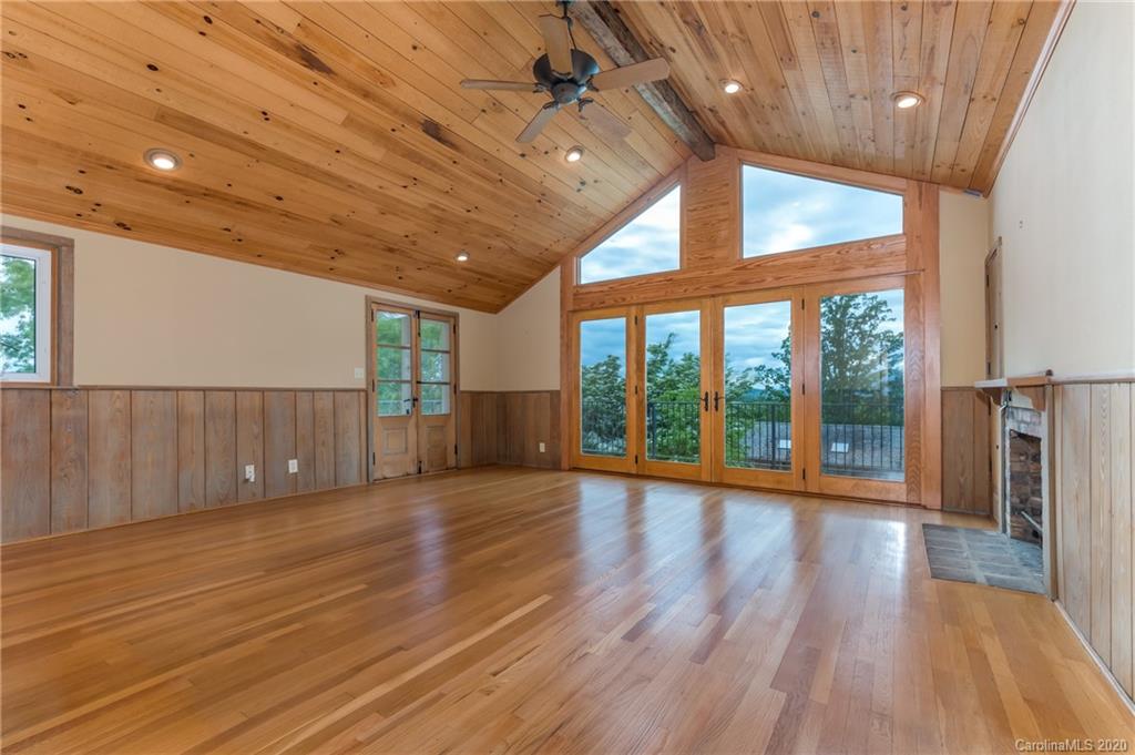 2468 Peniel Road Columbus, NC 28722 - Photo 19 of 47 a view of an empty room with wooden floor and a window