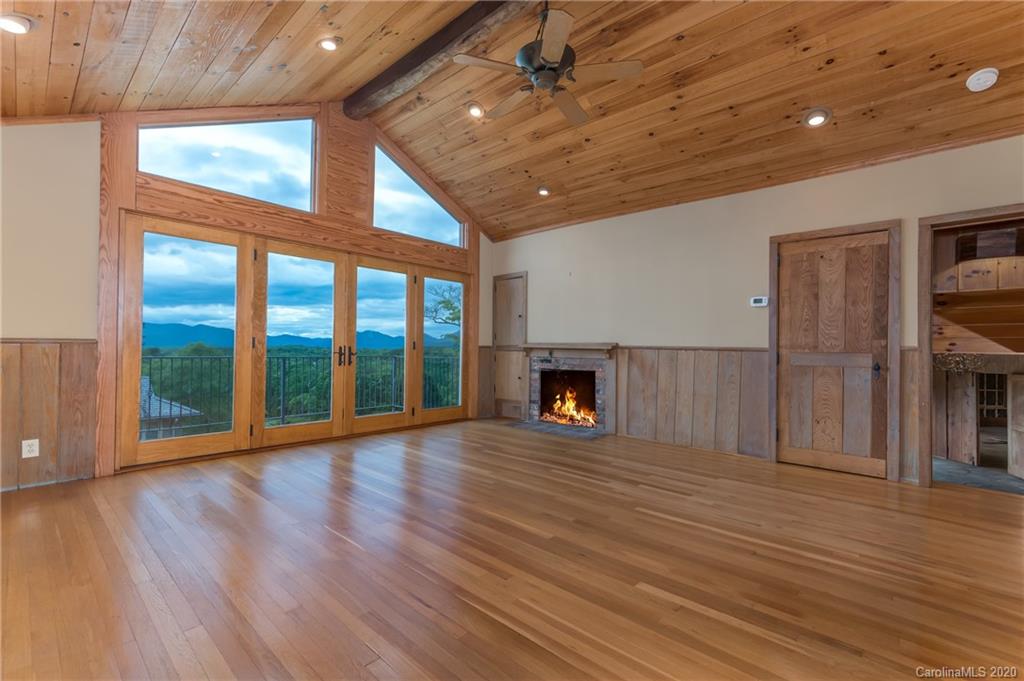 2468 Peniel Road Columbus, NC 28722 - Photo 20 of 47 a view of an empty room with wooden floor fireplace and a window