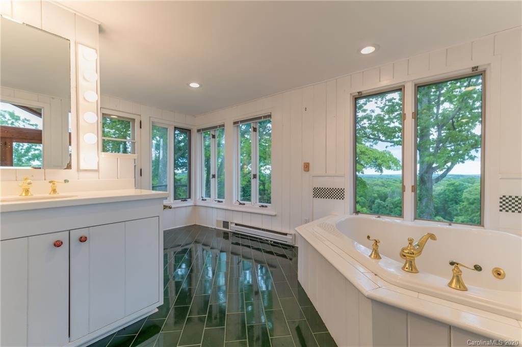 2468 Peniel Road Columbus, NC 28722 - Photo 23 of 47 a bathroom with a tub sink and window