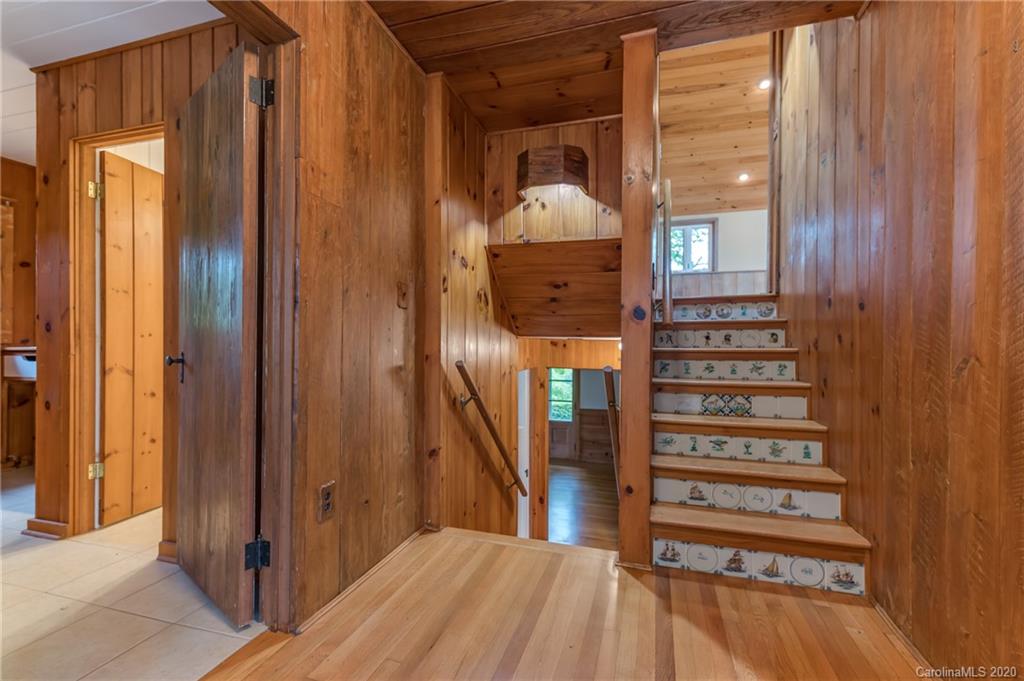 2468 Peniel Road Columbus, NC 28722 - Photo 24 of 47 a view of a hallway with wooden floor and staircase