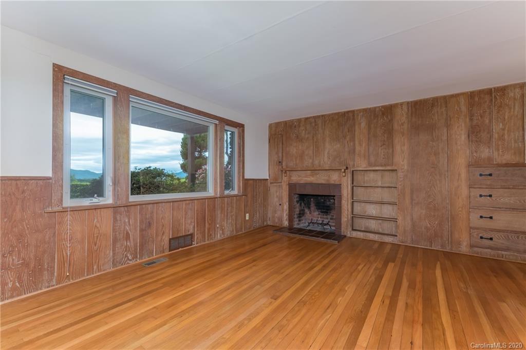 2468 Peniel Road Columbus, NC 28722 - Photo 27 of 47 a view of a livingroom with a fireplace and window