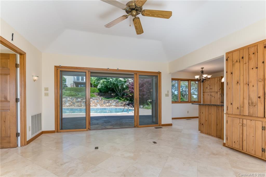 2468 Peniel Road Columbus, NC 28722 - Photo 32 of 47 a view of a kitchen with a refrigerator a ceiling fan and a large window