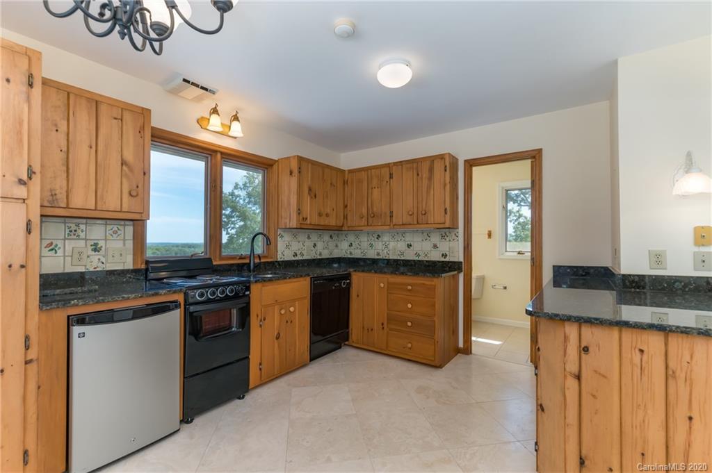 2468 Peniel Road Columbus, NC 28722 - Photo 33 of 47 a kitchen with stainless steel appliances granite countertop a stove a sink and a refrigerator