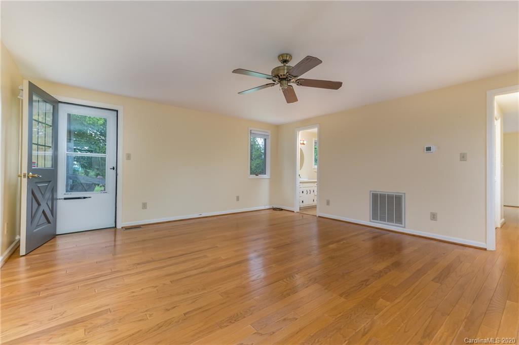 2468 Peniel Road Columbus, NC 28722 - Photo 36 of 47 a view of empty room with wooden floor and fan