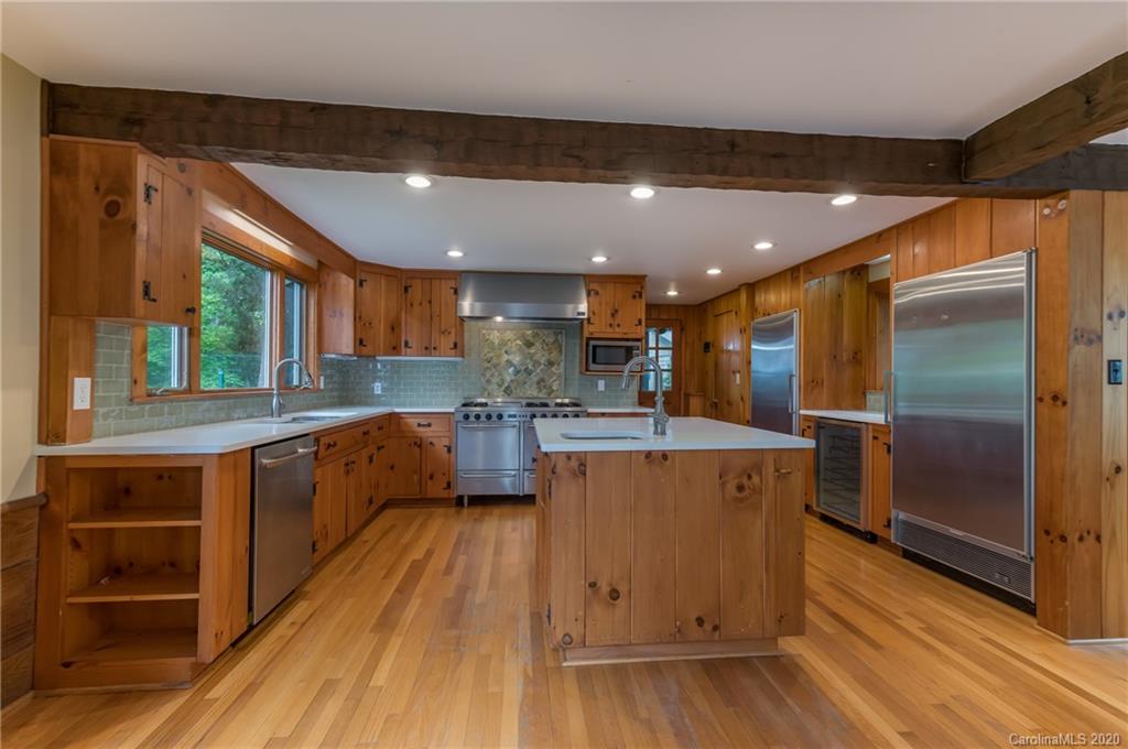 2468 Peniel Road Columbus, NC 28722 - Photo 10 of 47 a kitchen with stainless steel appliances granite countertop a stove a refrigerator a sink and a oven