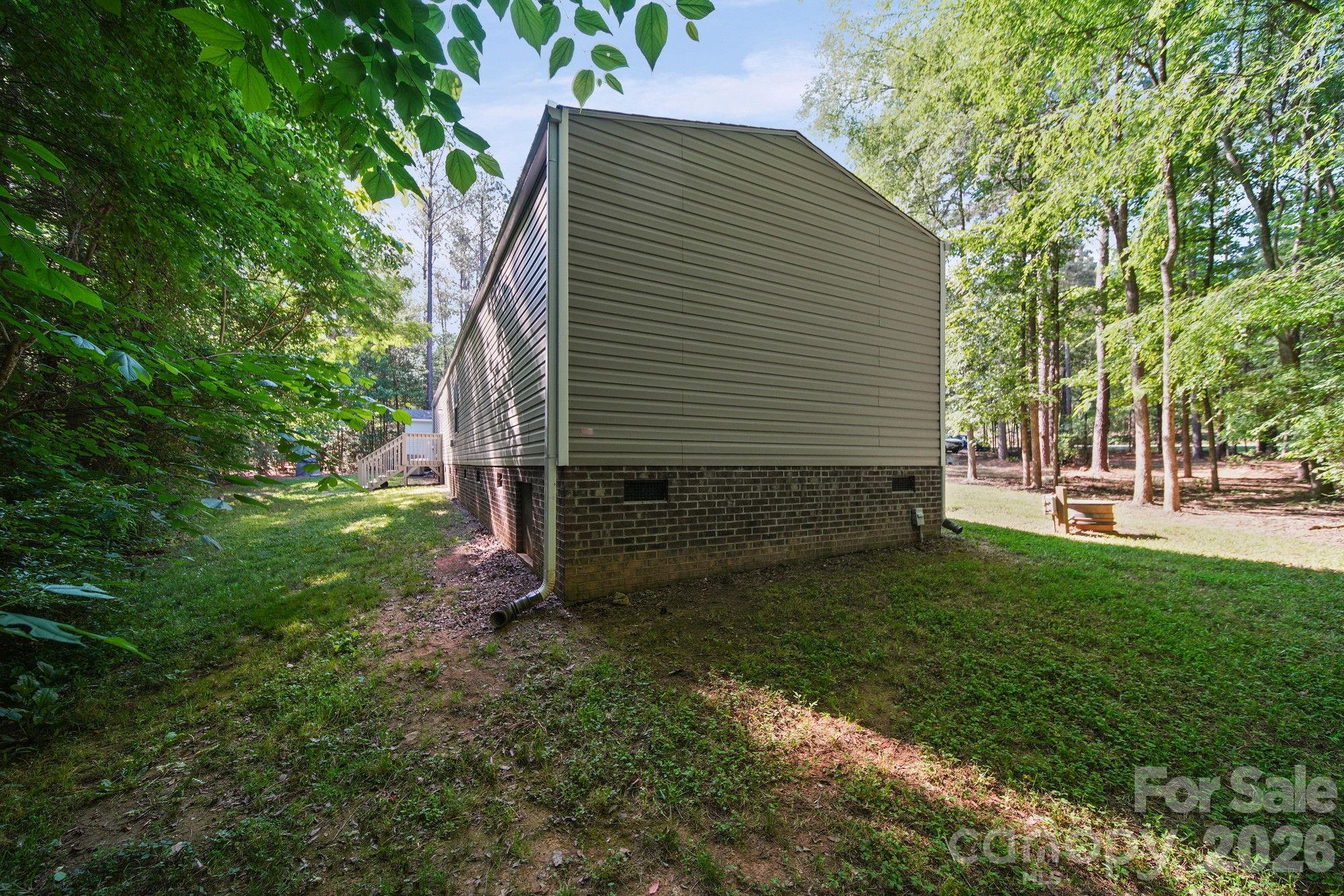 4507 White Store Road Wingate, NC 28174 - Photo 26 of 29 a view of backyard with a garden
