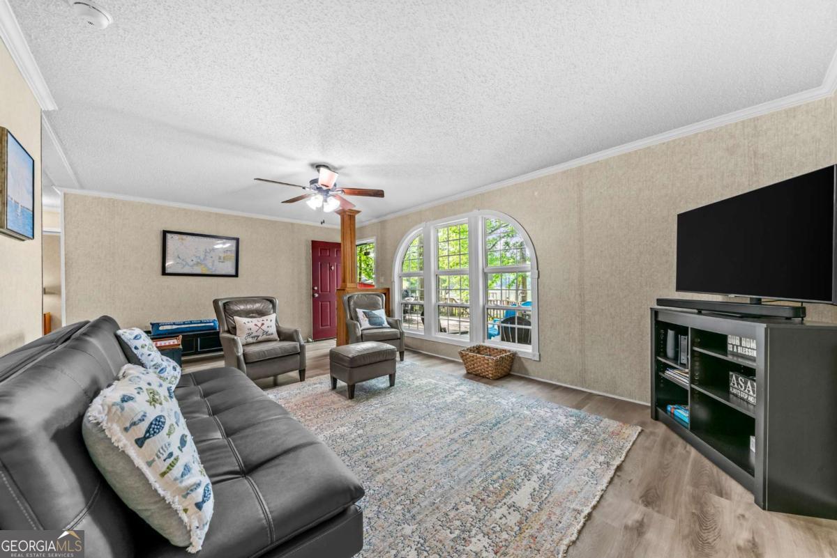 194 Phillips Road Eatonton, GA 31024 - Photo 17 of 57 a living room with furniture and a flat screen tv