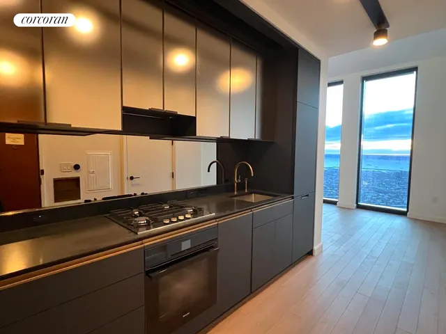 a kitchen with granite countertop a stove and cabinets