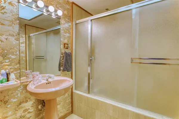 a bathroom with a sink vanity granite and a mirror