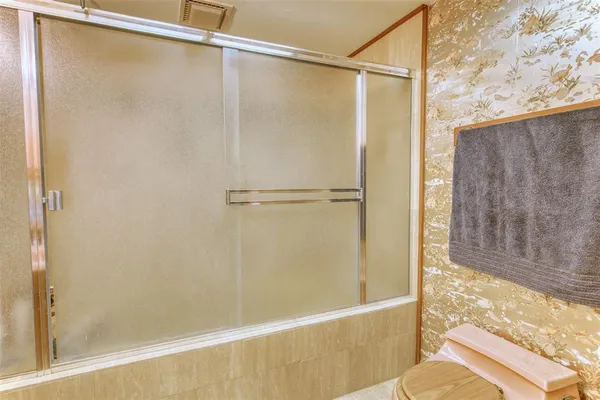a bathroom with a shower curtain and a curtain