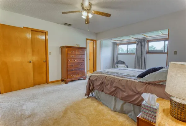 an aerial view of a tennis ground and a cars park side of the road