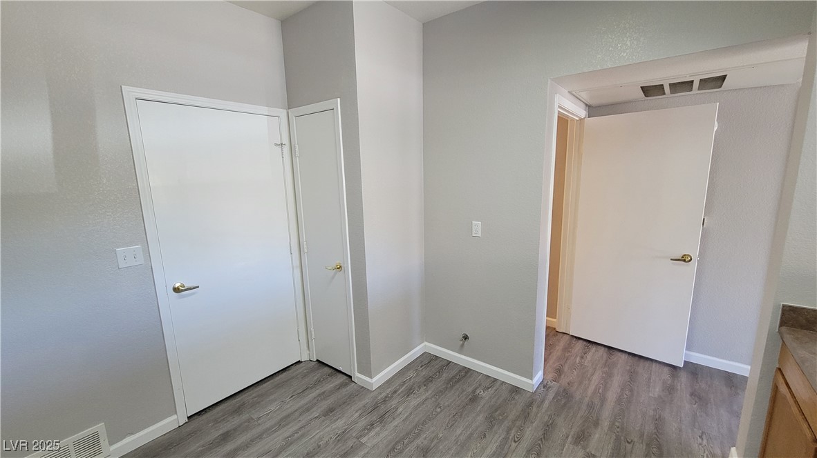 6650 West Warm Springs Road, Unit 1032 Las Vegas, NV 89118 - Photo 11 of 17 Unfurnished bedroom with light wood-type flooring and baseboards