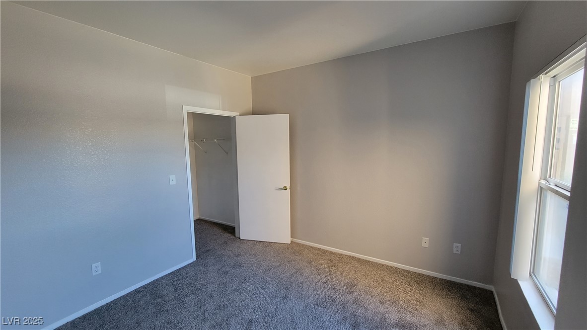 6650 West Warm Springs Road, Unit 1032 Las Vegas, NV 89118 - Photo 13 of 17 Carpeted spare room with baseboards