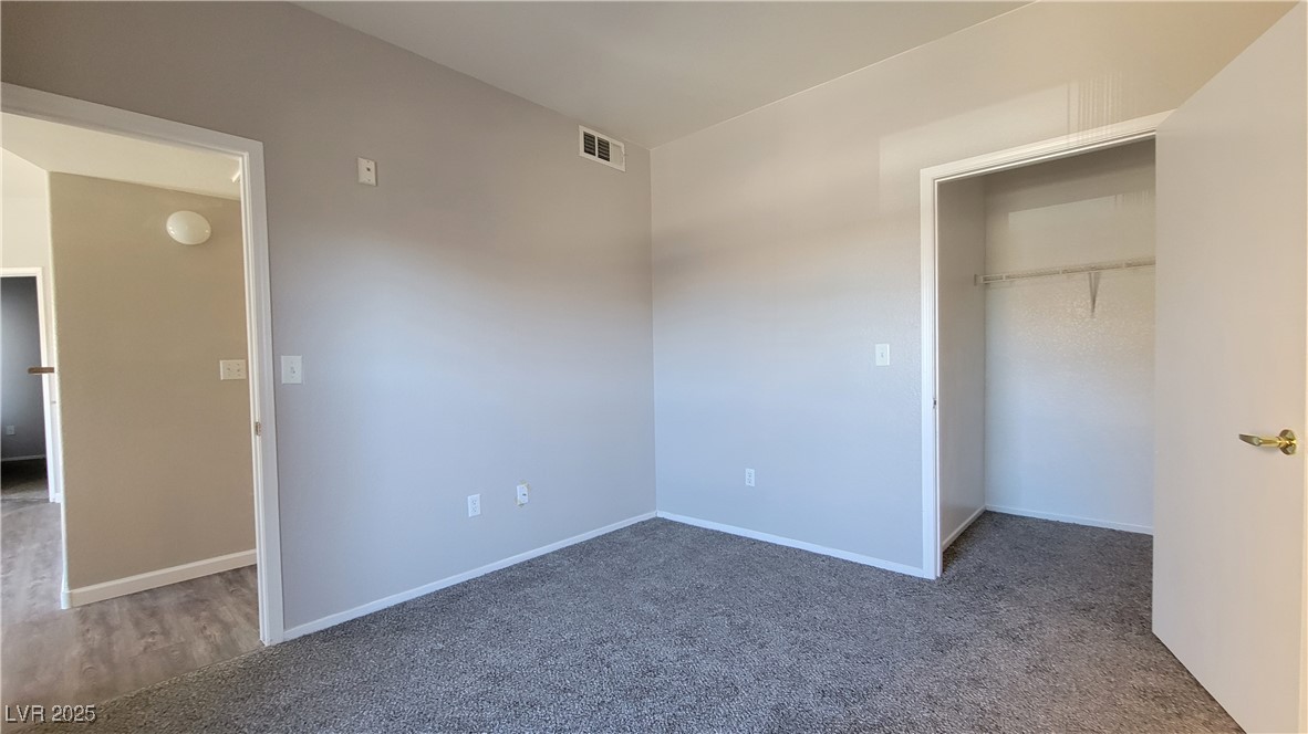 6650 West Warm Springs Road, Unit 1032 Las Vegas, NV 89118 - Photo 14 of 17 Unfurnished bedroom featuring carpet floors and a spacious closet