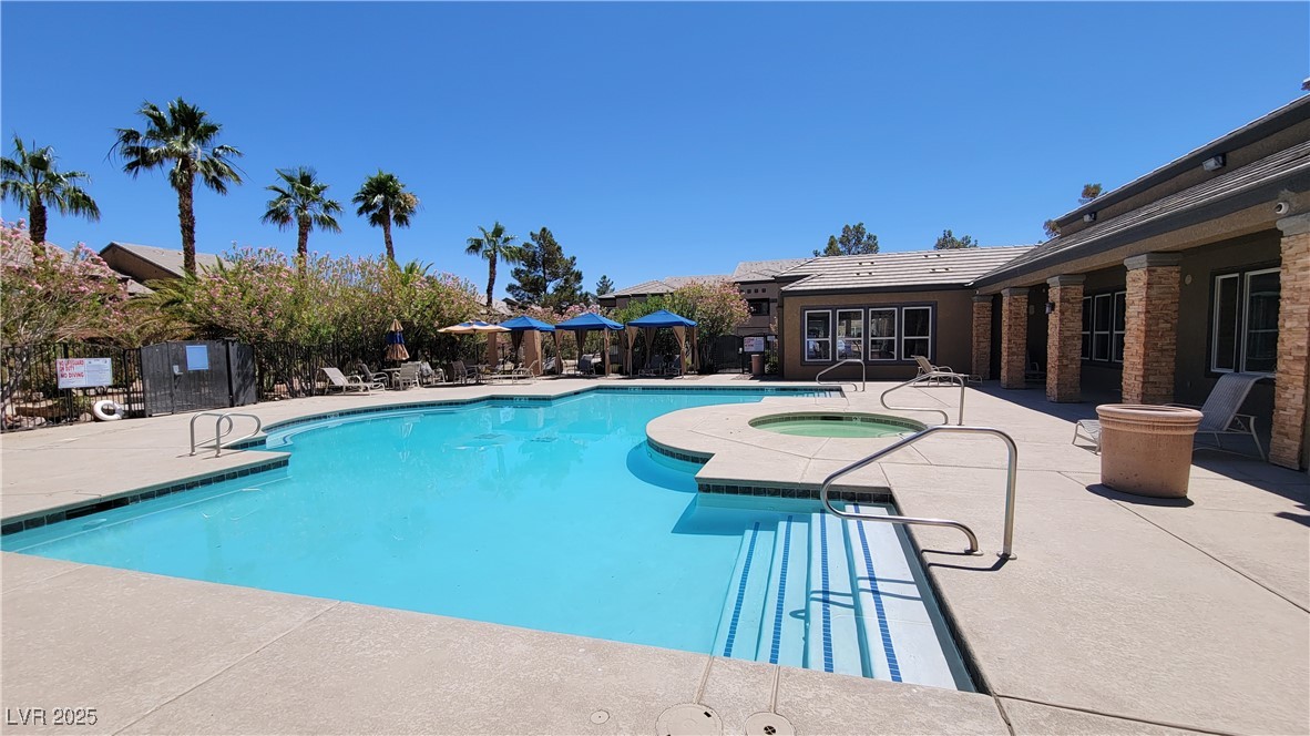 6650 West Warm Springs Road, Unit 1032 Las Vegas, NV 89118 - Photo 2 of 17 Community pool featuring a patio and a community hot tub