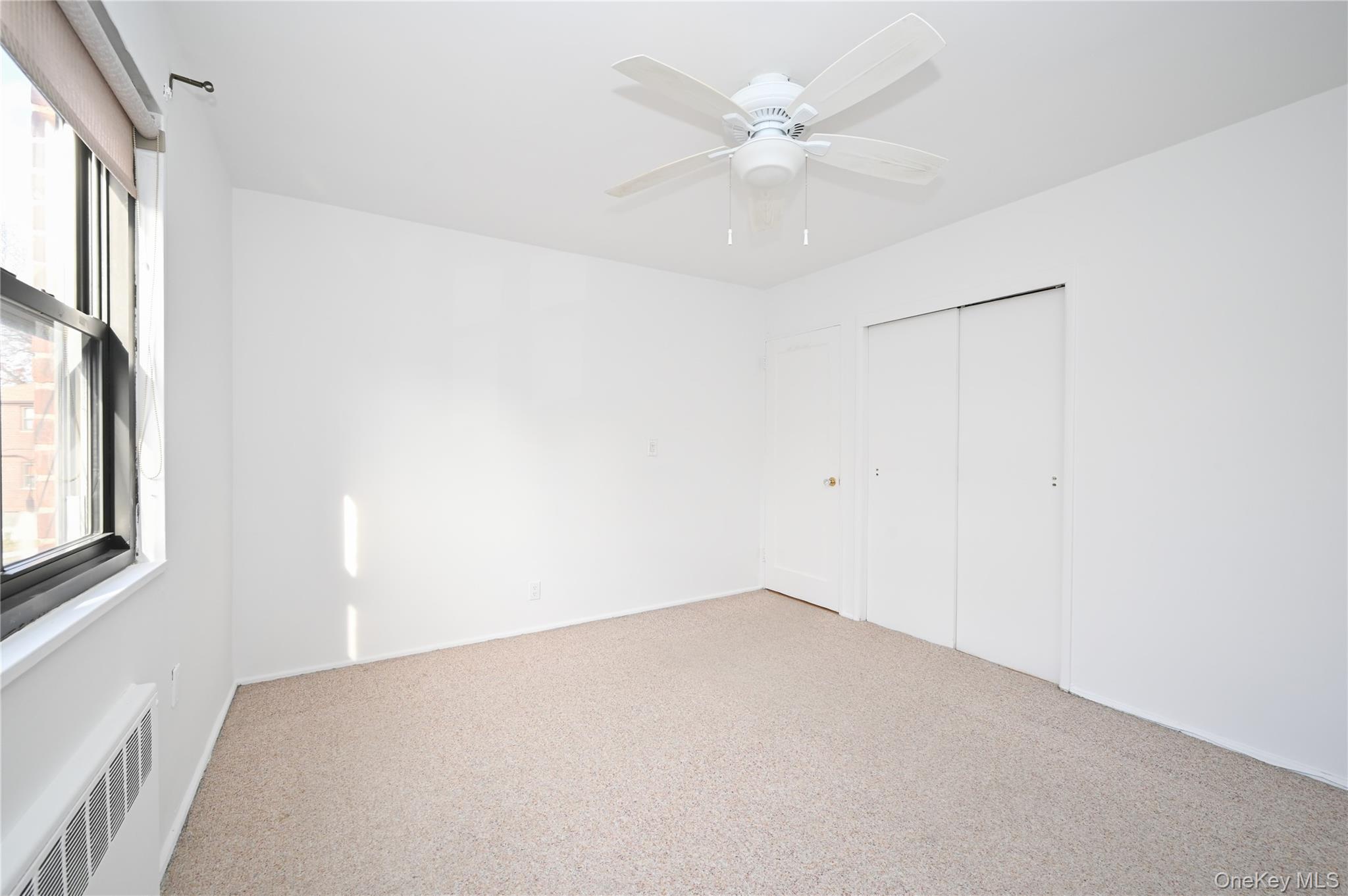 245-12 62nd Avenue, Unit G/3 LOWER Queens, NY 11362 - Photo 11 of 18 an empty room with a window