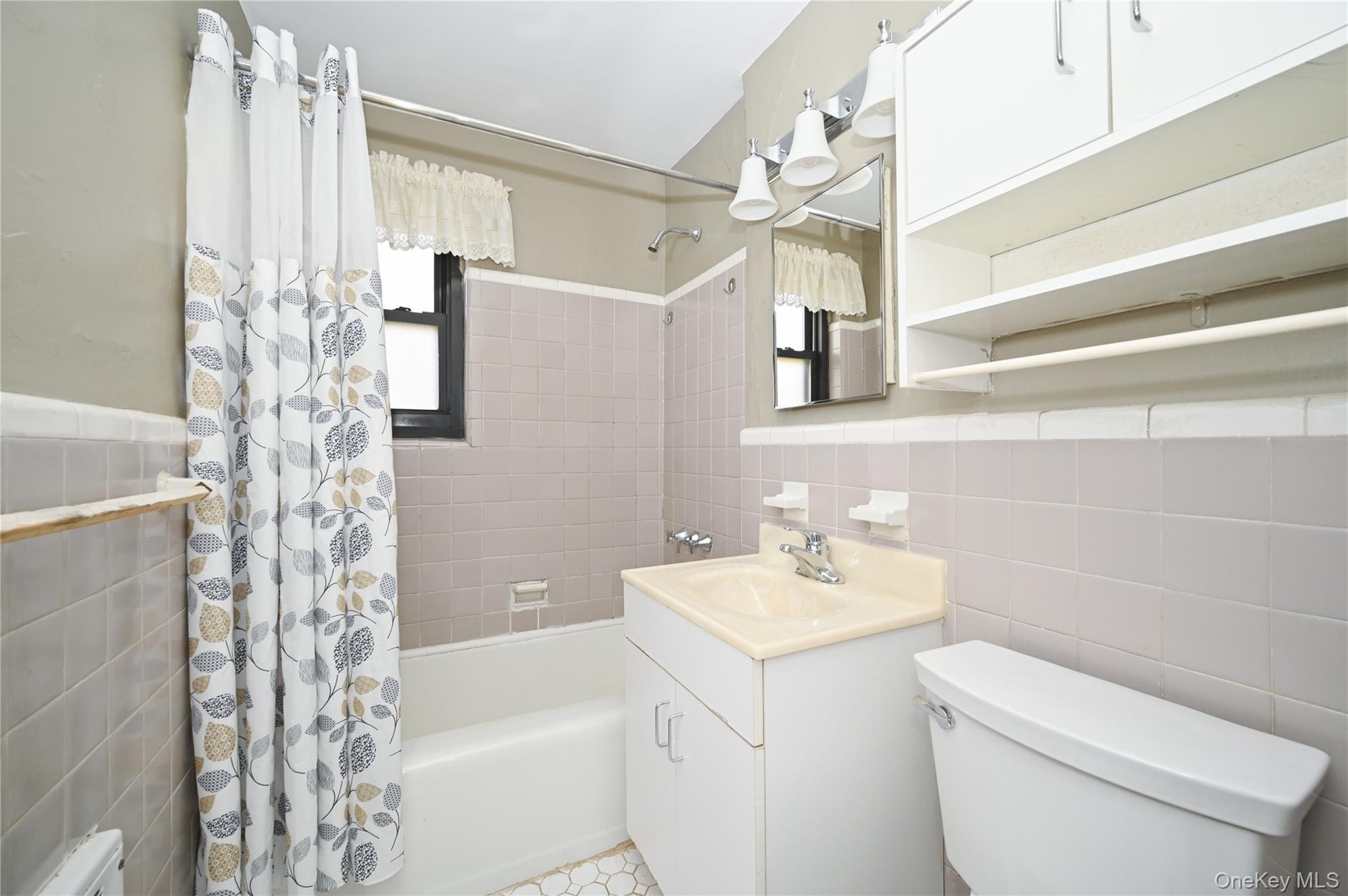 245-12 62nd Avenue, Unit G/3 LOWER Queens, NY 11362 - Photo 14 of 18 a bathroom with a sink a toilet and shower
