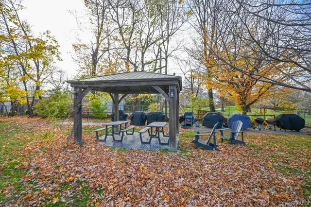 a view of bench sitting in middle of the forest