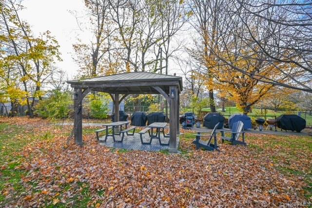 245-12 62nd Avenue, Unit G/3 LOWER Queens, NY 11362 - Photo 16 of 18 a view of bench sitting in middle of the forest