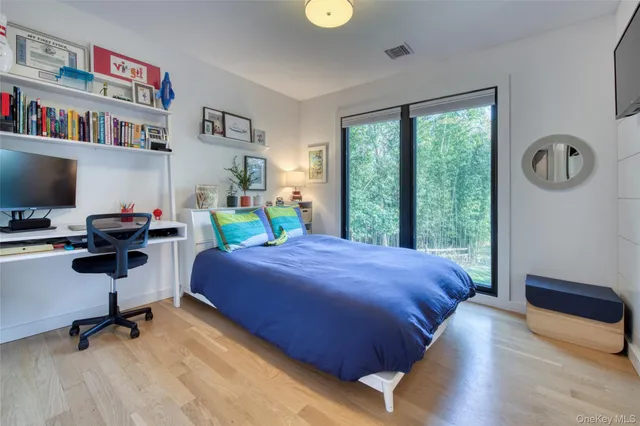 a bedroom with a bed and a bookshelf