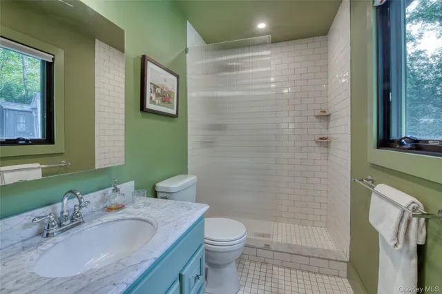 a bathroom with a sink toilet and shower