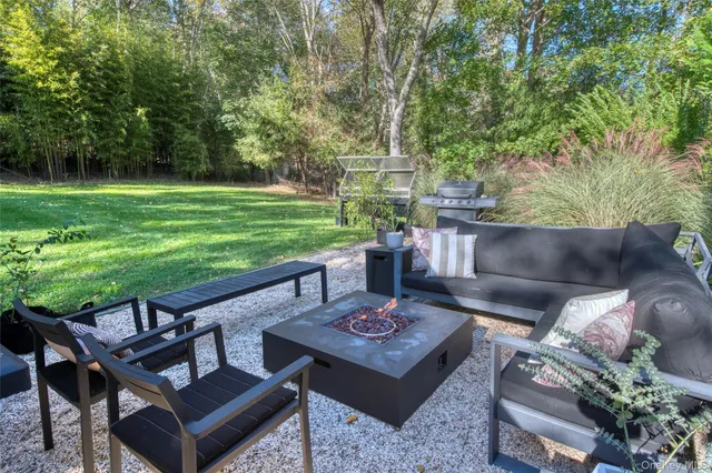 a view of a backyard with couches table and chairs