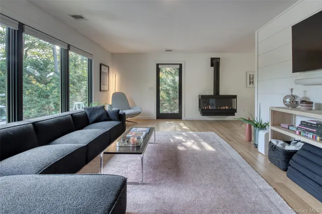 a living room with furniture fireplace and a flat screen tv