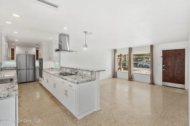 a kitchen with a sink refrigerator and cabinets