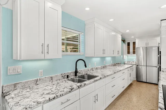 a kitchen with stainless steel appliances granite countertop a stove and a sink