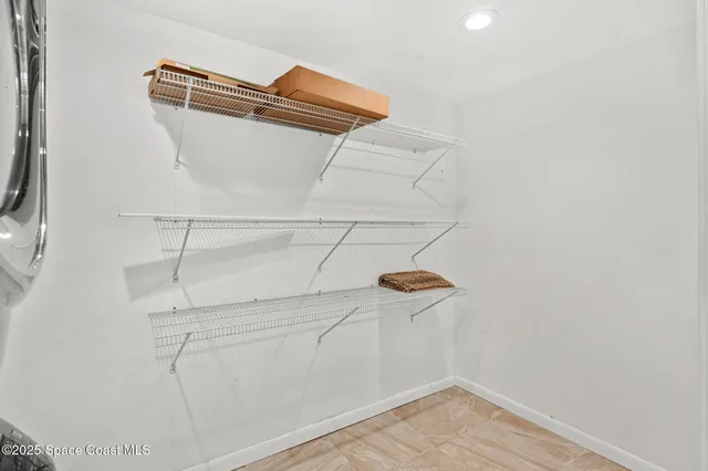 a view of a storage and utility room with washer and dryer